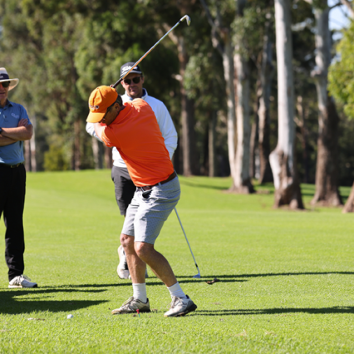 three men playing golf