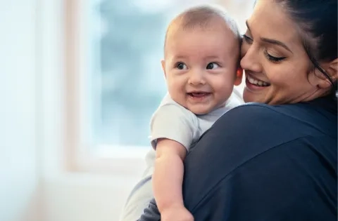 Mum and baby smiling